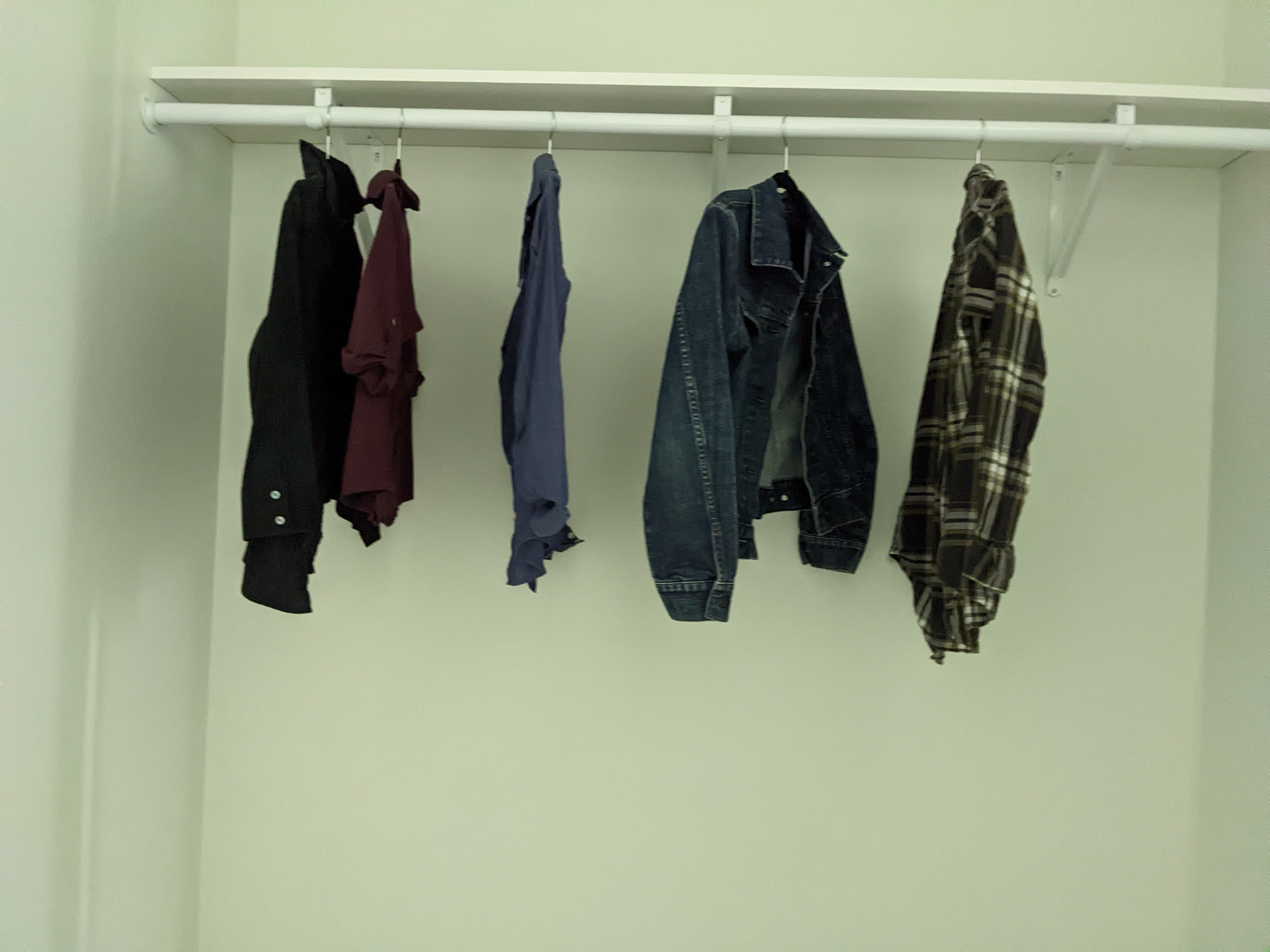 clothes hanging in the closet
